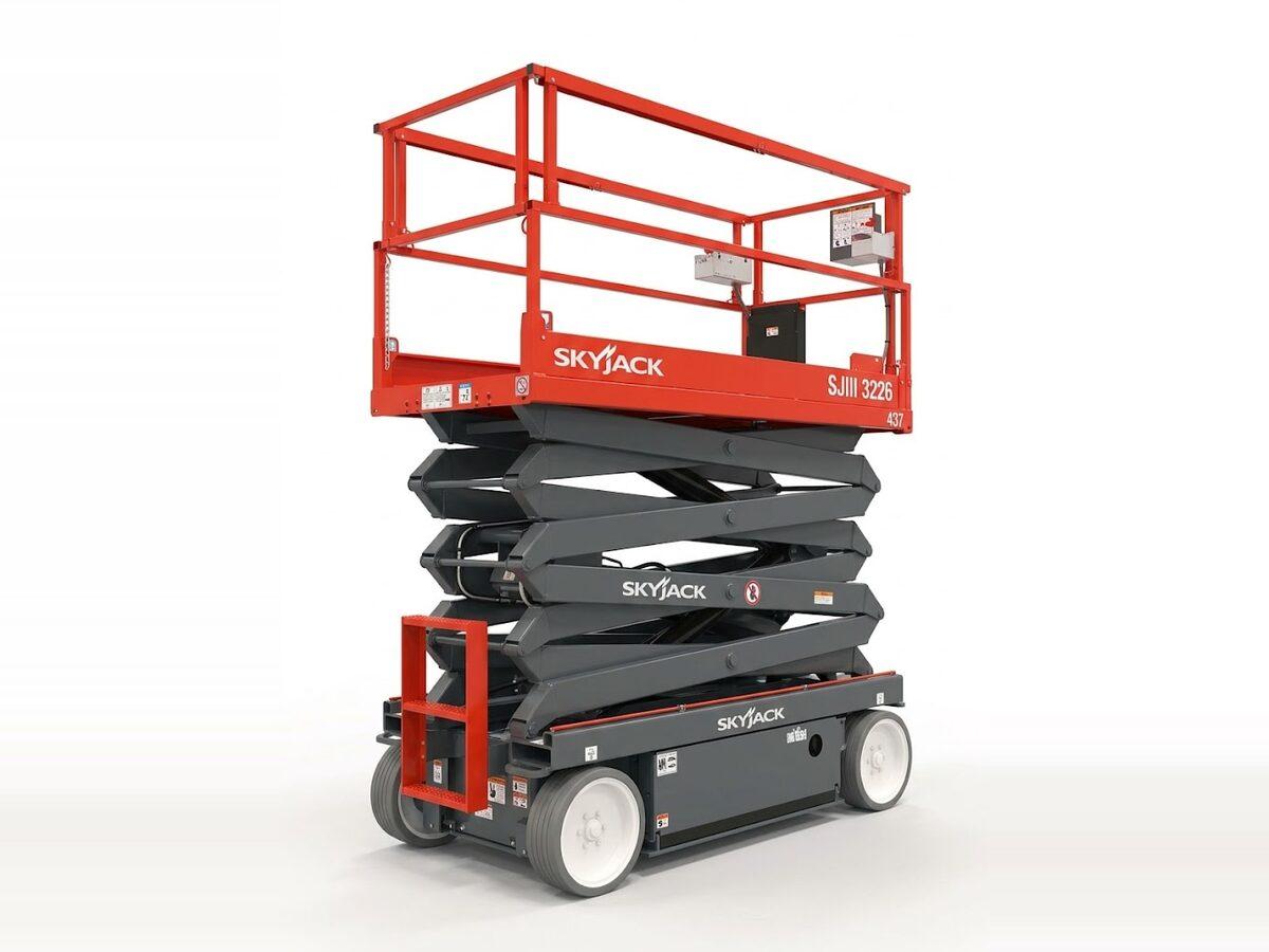 Skyjack SJIII 3226 electric scissor lift raised to full height, with non-marking tires for finished floors in Phoenix-area buildings