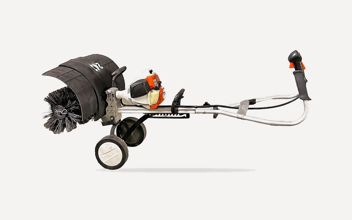 Stihl MM 56 C-E Yard Boss with a power broom for grooming artificial turf in Phoenix, AZ