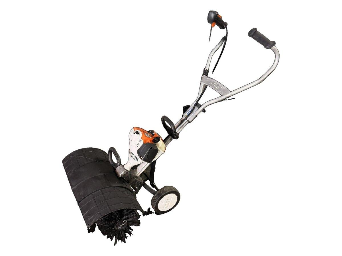 Stihl MM 56 C-E Yard Boss turf brush with its support wheels and handlebars, for turf maintenance across the Phoenix valley