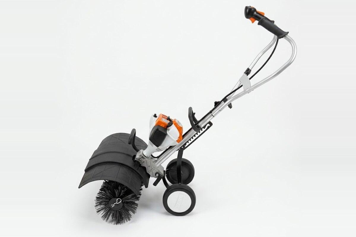 Stihl MM 56 C-E Yard Boss with a power broom head for artificial turf brushing, for rent in Phoenix, AZ