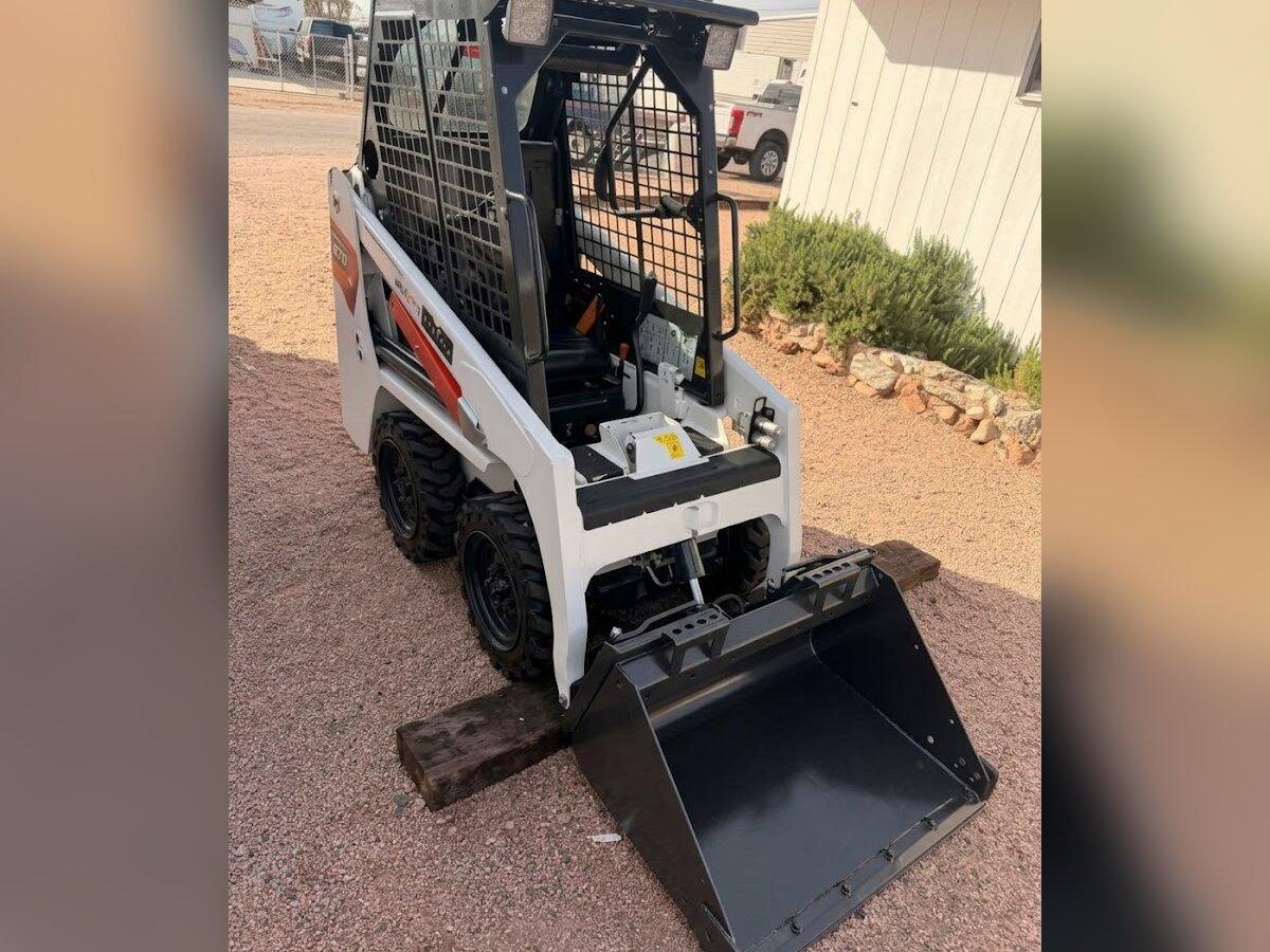 Compact mini skid steer rental delivered by Summit Rentals to a residential property in Apache Junction, AZ