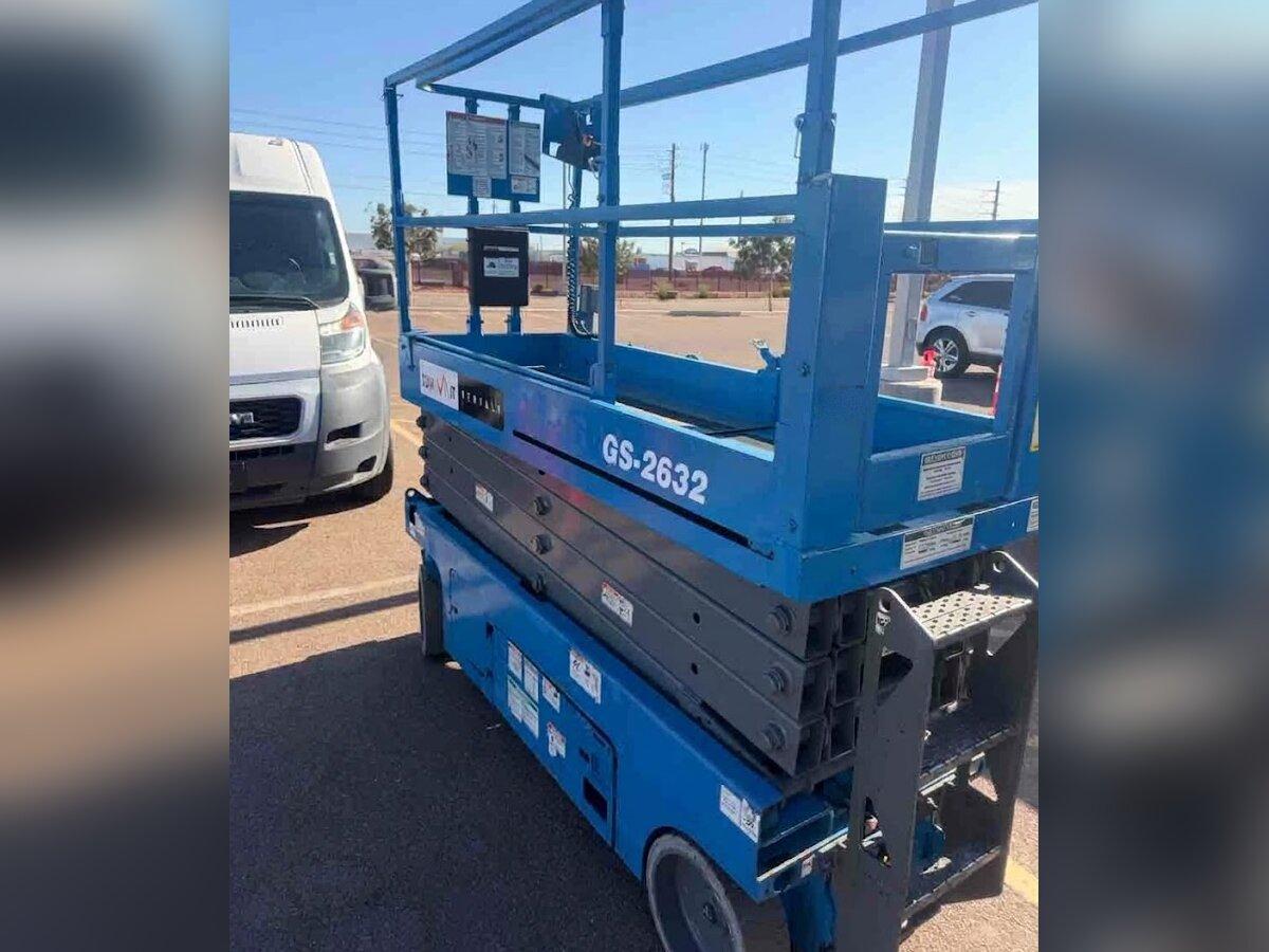 Genie GS-2632 26 ft scissor lift rental delivered by Summit Rentals to a retail parking lot in Avondale, AZ