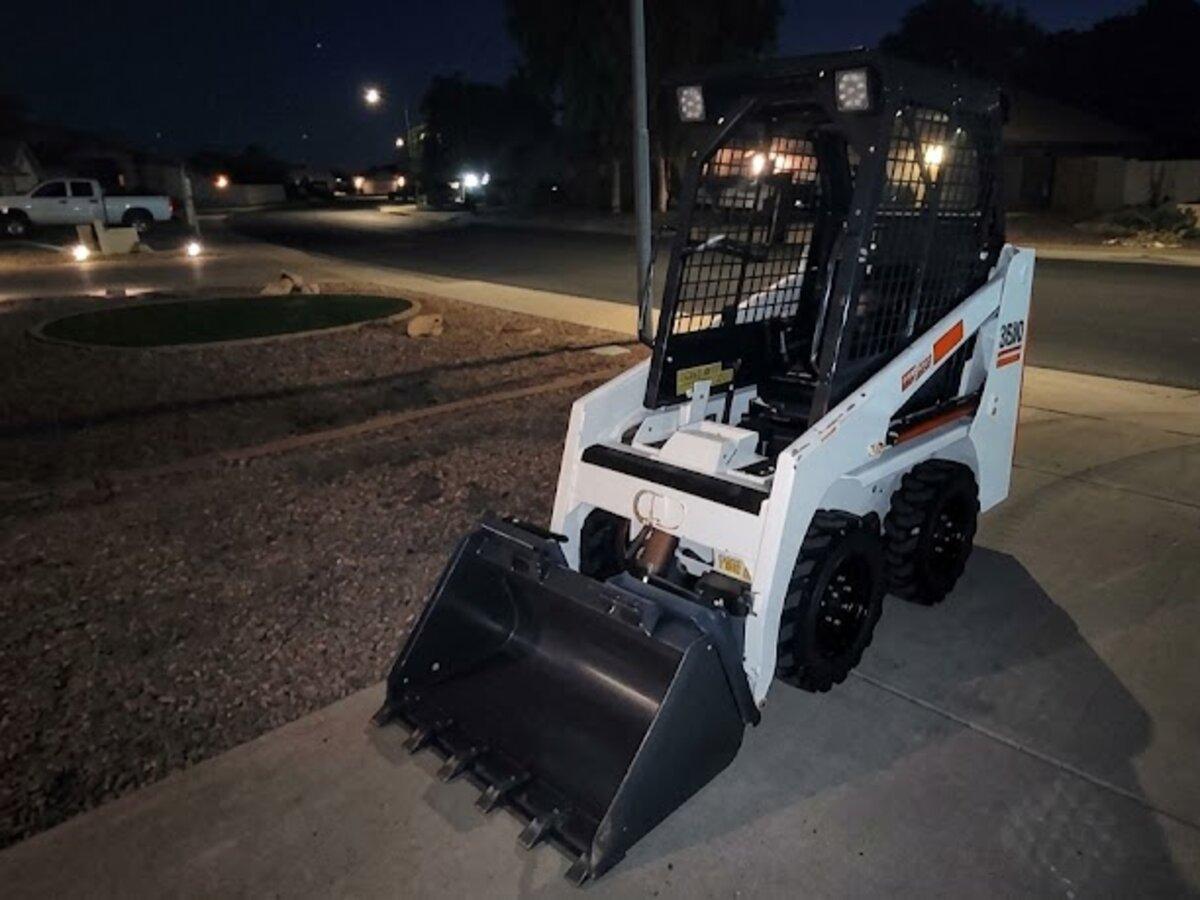 Compact mini skid steer rental delivered early in the morning by Summit Rentals to a residential street in Avondale, AZ