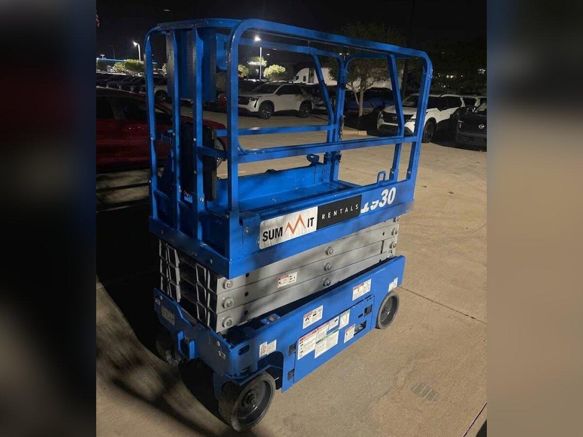 Genie GS-1930 19 ft electric scissor lift rental delivered early in the morning by Summit Rentals to a dealership lot in Avondale, AZ