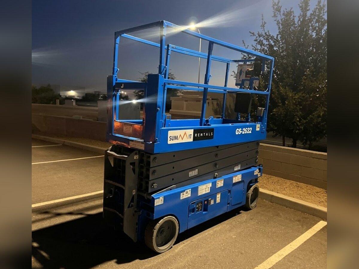 Genie GS-2632 26 ft electric scissor lift rental delivered early in the morning by Summit Rentals to a commercial parking lot in Chandler, AZ
