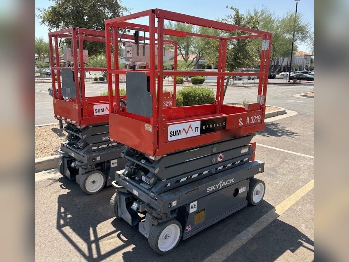 Two Skyjack SJIII 3219 19 ft electric scissor lift rentals delivered by Summit Rentals to a shopping center in Chandler, AZ