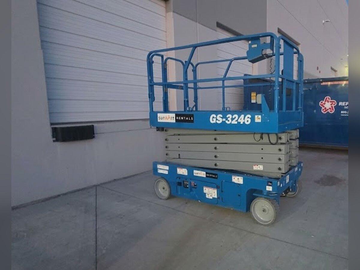 Genie GS-3246 32 ft scissor lift rental delivered early in the morning by Summit Rentals to a warehouse loading dock in Glendale, AZ