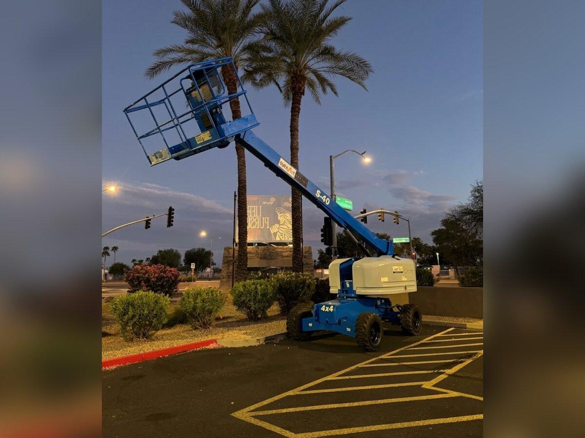 Genie S-40 straight boom lift with the boom extended, delivered early in the morning by Summit Rentals to a shopping center in Peoria, AZ
