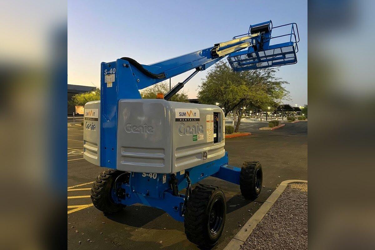 Summit Rentals Genie S-40 40 ft straight boom lift delivered early in the morning to a commercial parking lot in Peoria, AZ