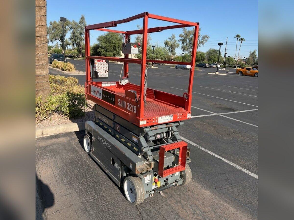Skyjack SJIII 3219 19 ft electric scissor lift rental delivered by Summit Rentals to a shopping center parking lot in Tempe, AZ