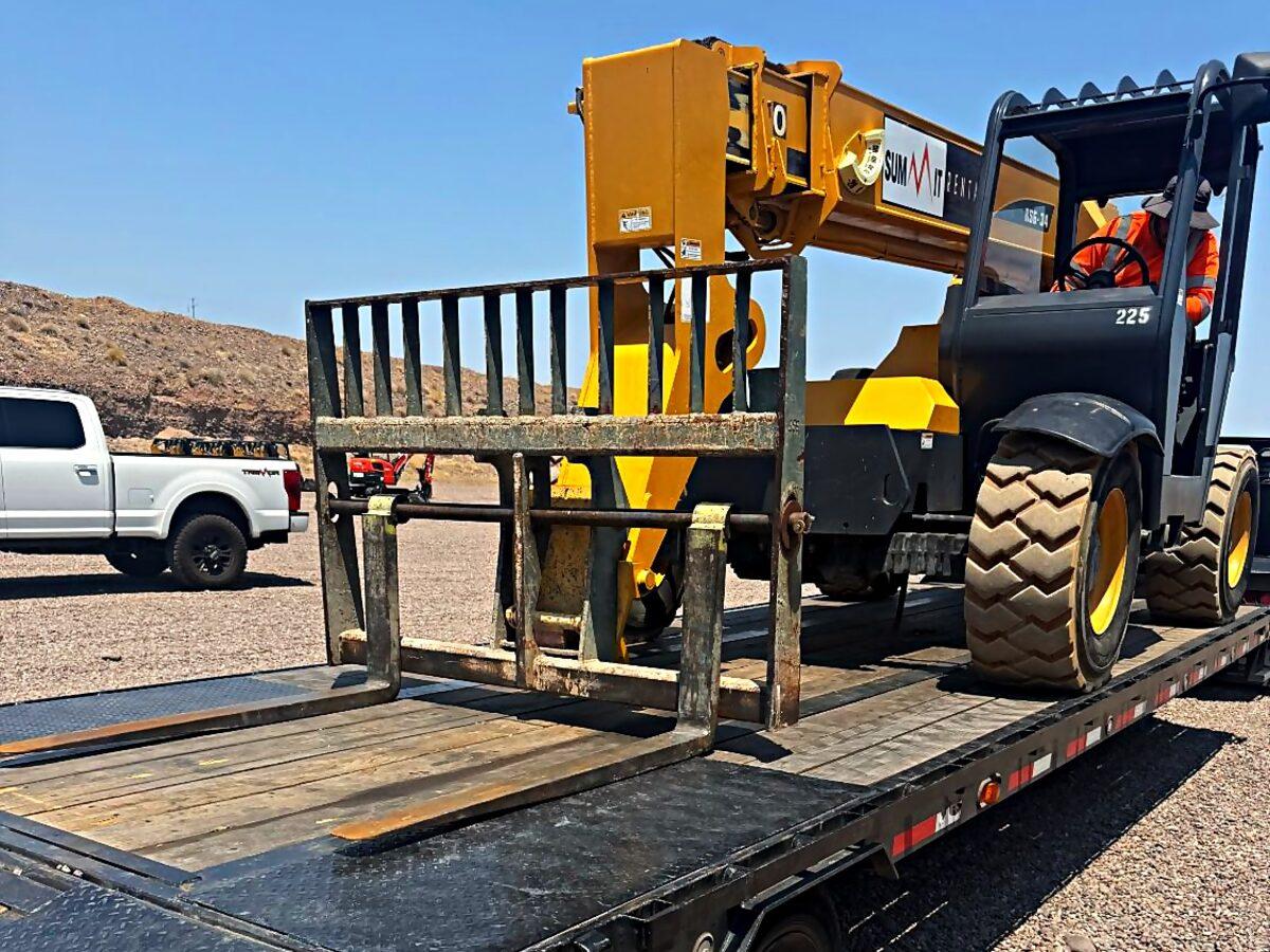 Telehandler loaded on a Summit Rentals gooseneck trailer for valleywide delivery across metro Phoenix, AZ